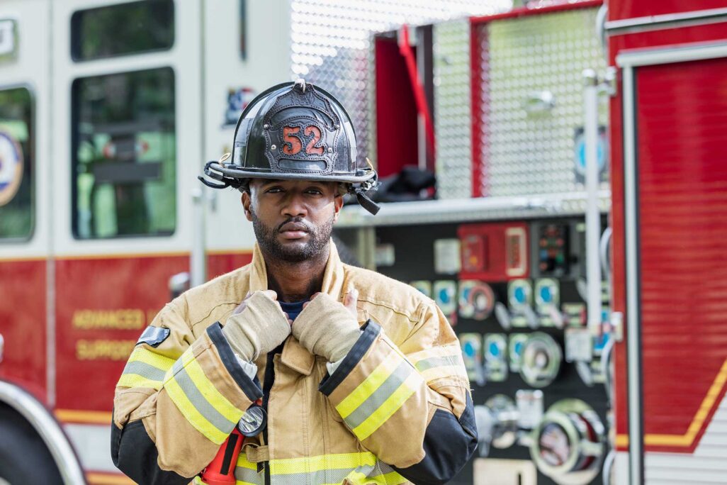 fireman standing in front of fire truck