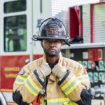 fireman standing in front of fire truck